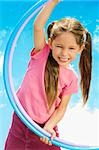 Portrait of a girl playing with two plastic hoops