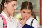 Close-up of two schoolgirls looking at a textbook