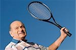 Close-up of a senior man holding a tennis racket