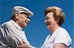 Side profile of a senior couple holding each other and smiling