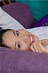 Portrait of a young woman lying down and smiling