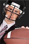 Close-up of a businessman wearing a football helmet