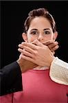 Close-up of a person's hand covering a businesswoman's mouth