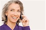 Close-up of a businesswoman talking on a mobile phone and thinking