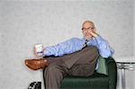 Close-up of a businessman sitting in an armchair and thinking