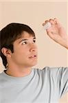 Close-up of a young man putting eye drops in his eyes