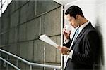 Side profile of a businessman reading a newspaper