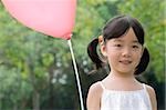 Portrait of a girl with a balloon and smiling