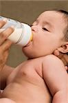 Close-up of a baby boy drinking milk from a milk bottle