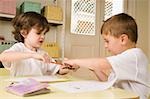 Boy snatching a pencil from a girl in a classroom