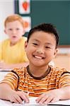 Portrait of a boy smiling in a classroom