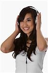 Close-up of a young woman listening to music with headphones and smiling