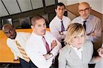 Portrait of business executives standing in a board room