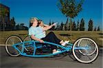 Two senior women riding a quadracycle