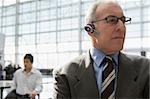 Close-up of a businessman wearing a hands free device at an airport