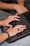 Close-up of a person's hands using a laptop