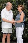 Senior couple holding each other hands in a garden