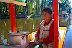 Mature woman traveling on a trajineras, Xochimilco, Mexico