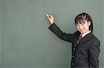 High school girl writing on blackboard