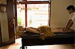 Young woman lying down on massage table