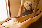 Young woman having leg massage