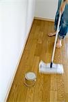 A woman cleaning floor with mop, blurred motion