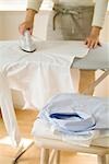 A woman ironing shirt