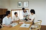 Family sitting in dining table