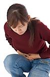 A young woman suffering from abdominal pain