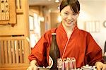 Waitress carrying a tray of beer
