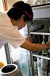 Young man looking into refrigerator