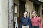 Young women standing in front of restaurant