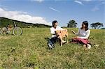 Young couple playing with dog