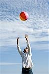 Young man playing with beach ball