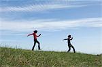 Young couple skipping in field