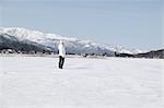 Young woman standing in snow