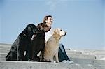 Young woman and Labrador retrievers