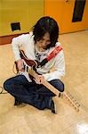 Young man playing electric guitar