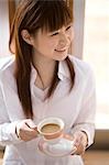 Young woman having cup of coffee