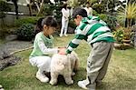 Children playing with dog