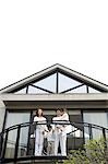 Family standing on balcony