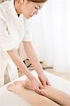 Massage therapist applying foot massage