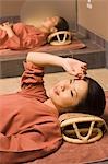 Young women lying at bedrock bath