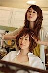 Hairdresser giving customer head massage