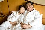 Mature couple relaxing in bed