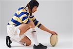 Rugby player placing ball