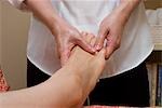 Therapist massaging patient's foot