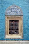 Detail of window with Arabic script on tilework above, in the Green Mosque in Bursa, Anatolia, Turkey, Asia Minor, Eurasia