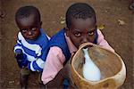 Portrait of young boys drinking goat's milk from gourd, Kenya, East Africa, Africa