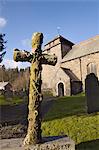 Carved stone cross headstone in front of the 14th century St. Idloes parish church, the only church dedicated to 7th century saint, Llanidloes, Powys, Wales, United Kingdom, Europe